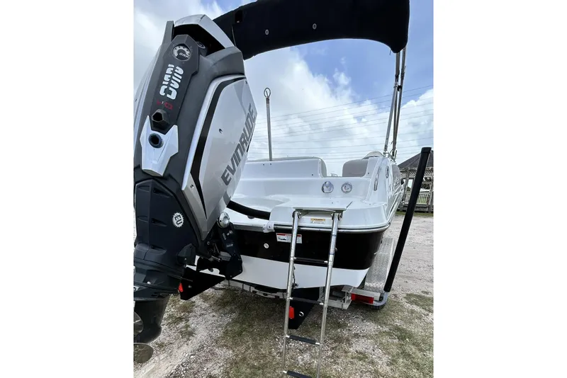 Slide: The Image of 2018 Hurricane SunDeck Sport 232 OB boat with Evinrude outboard motor and ladder. - 11