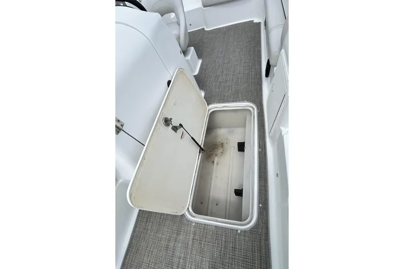 Slide: The Image of Open storage compartment on 2018 Hurricane SunDeck Sport 232 OB boat interior. - 14