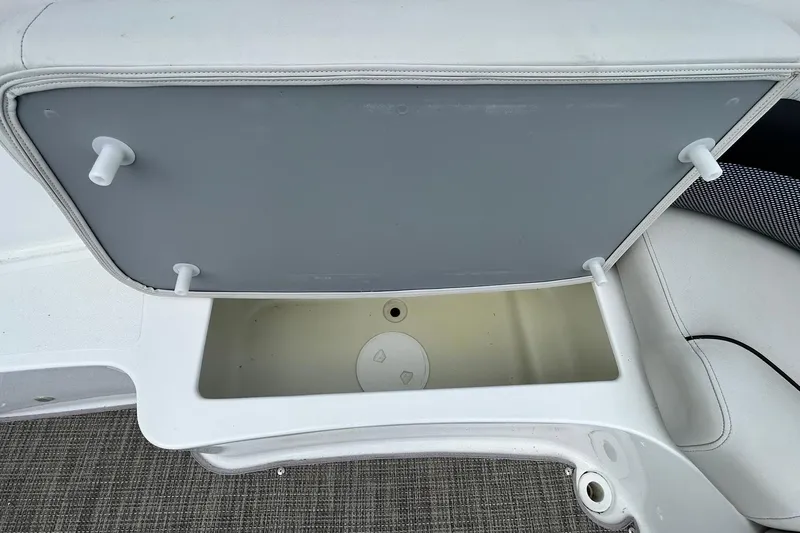 Slide: The Image of Storage compartment on a 2018 Hurricane SunDeck Sport 232 OB boat, open and empty. - 18