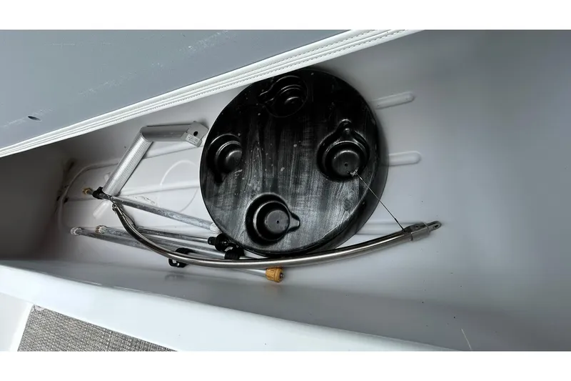 Slide: The Image of Storage compartment of 2018 Hurricane SunDeck Sport 232 OB boat with table and metal frame. - 19