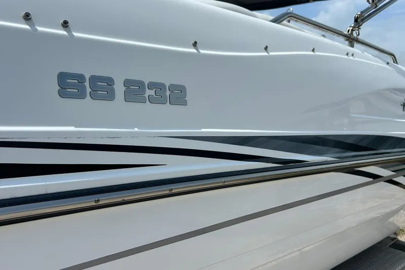 Slide: The Image of 2018 Hurricane SunDeck Sport 232 OB boat side view with SS 232 emblem. - 2