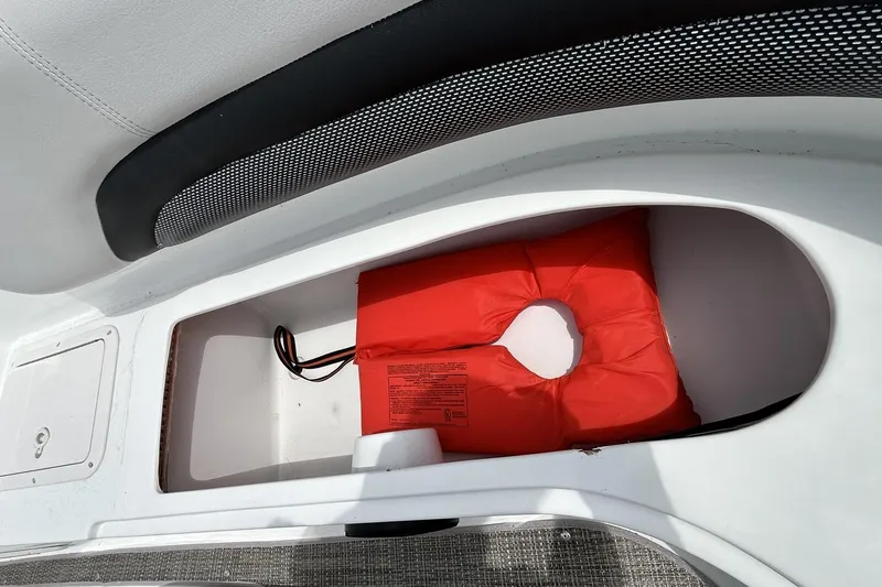 Slide: The Image of Storage compartment with life jacket on 2018 Hurricane SunDeck Sport 232 OB boat. - 21