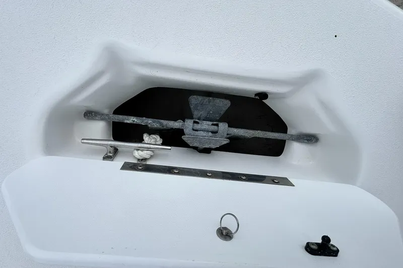 Slide: The Image of Anchor compartment of 2018 Hurricane SunDeck Sport 232 OB boat, featuring secure rope and cleat. - 25