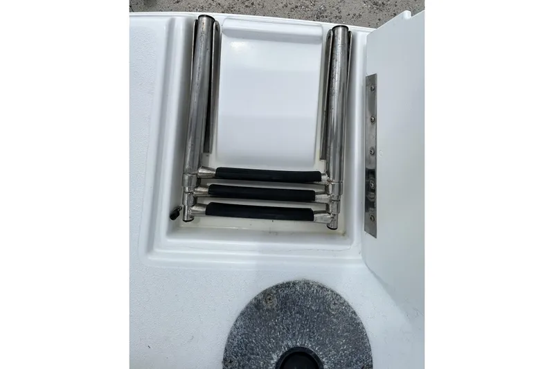 Slide: The Image of 2018 Hurricane SunDeck Sport 232 OB boat ladder, folded and stored in compartment. - 27