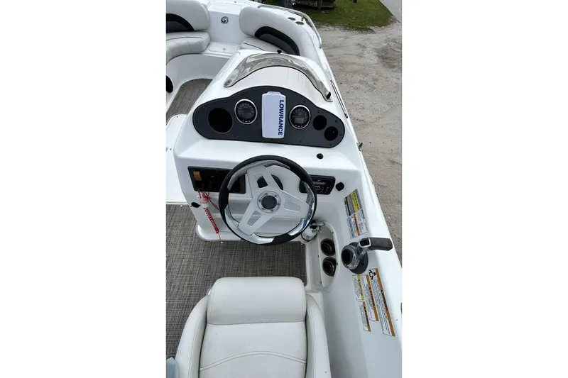 Slide: The Image of 2018 Hurricane SunDeck Sport 232 OB boat dashboard with steering wheel and controls. - 28