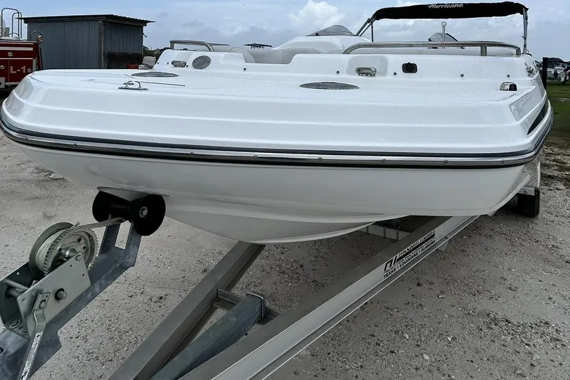 Slide: The Image of 2018 Hurricane SunDeck Sport 232 OB boat on trailer, parked outdoors. - 7