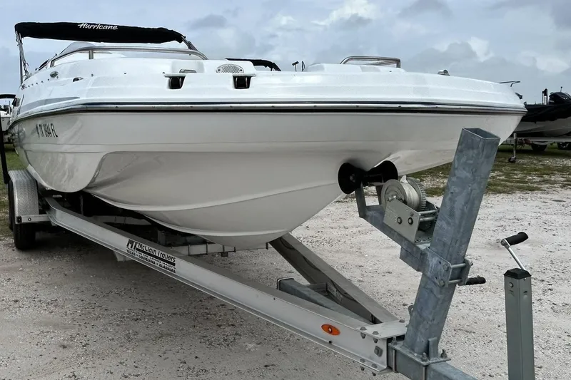 Slide: The Image of 2018 Hurricane SunDeck Sport 232 OB boat on trailer, ready for transport. - 8