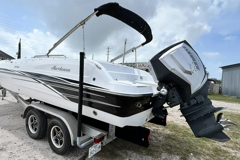 Slide: The Image of 2018 Hurricane SunDeck Sport 232 OB boat on trailer with Evinrude engine. - 9
