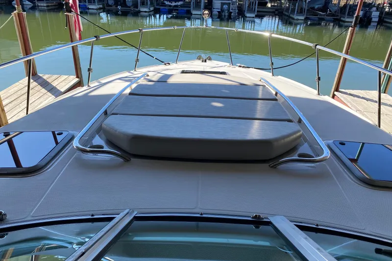 Slide: The Image of 2007 Chaparral 350 Signature boat docked, featuring spacious deck and sleek design. - 7
