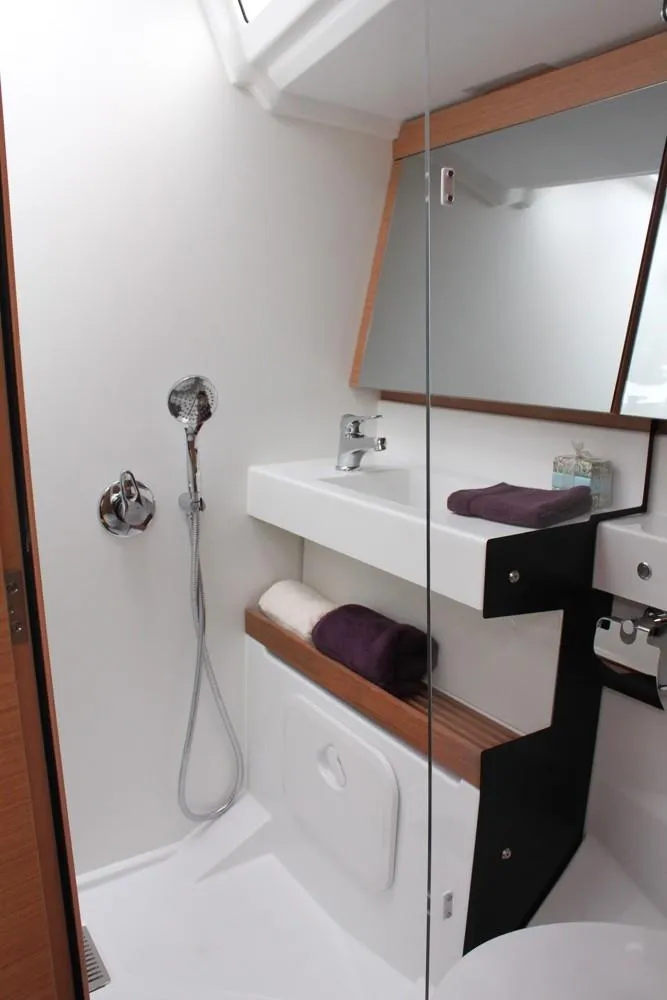 Slide: The Image of Modern bathroom in 2025 Jeanneau Sun Odyssey 440 yacht with sleek fixtures and storage. - 10
