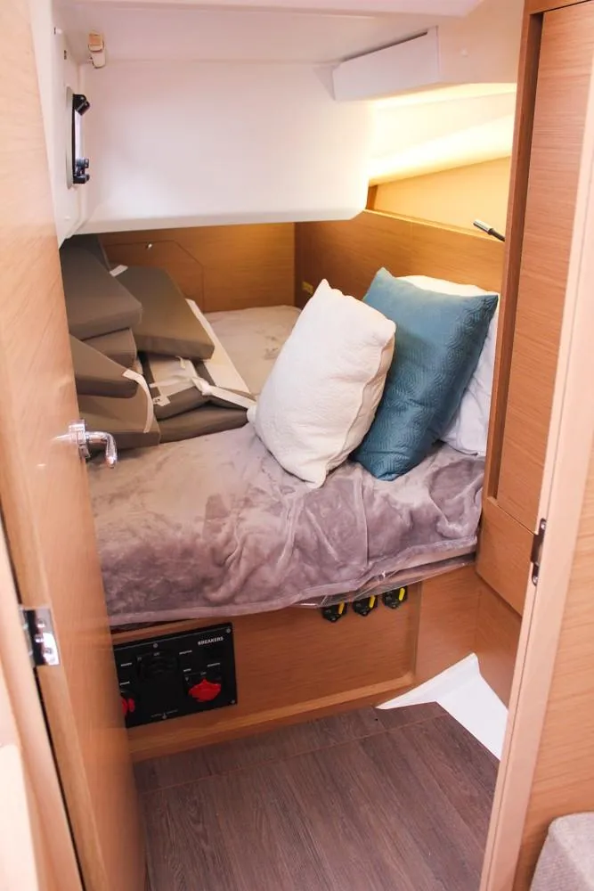 Slide: The Image of Cozy cabin interior of 2025 Jeanneau Sun Odyssey 440 sailboat with plush bedding. - 30