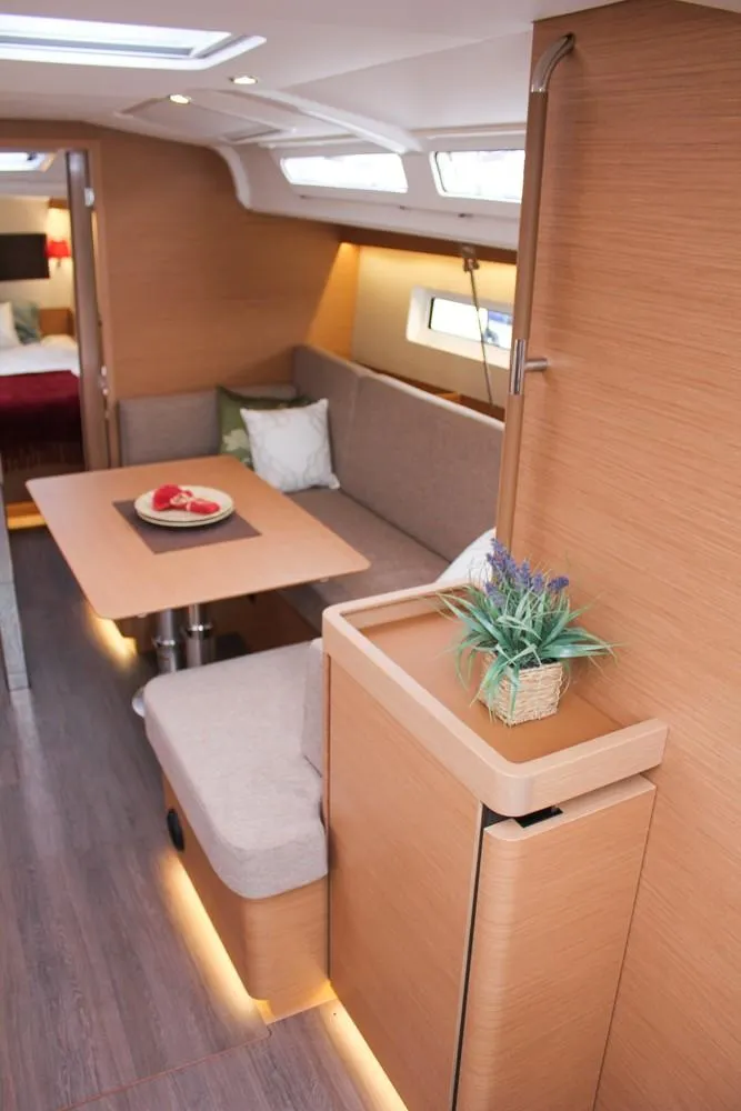 Slide: The Image of Interior of 2025 Jeanneau Sun Odyssey 440 yacht, featuring modern seating and dining area. - 42