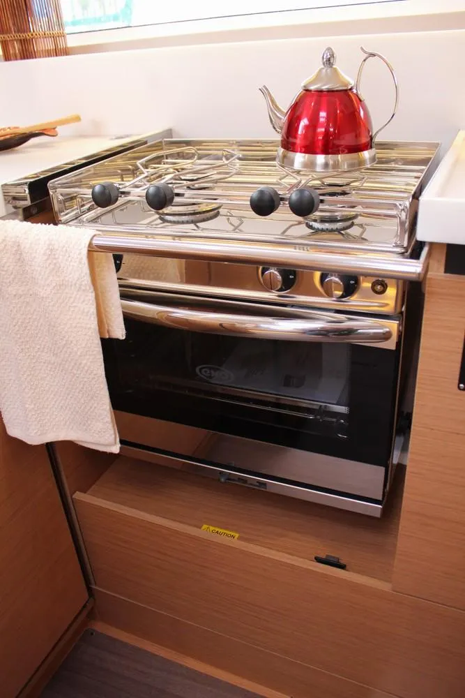 Slide: The Image of Modern kitchen in 2025 Jeanneau Sun Odyssey 440 yacht with stove and red kettle. - 15