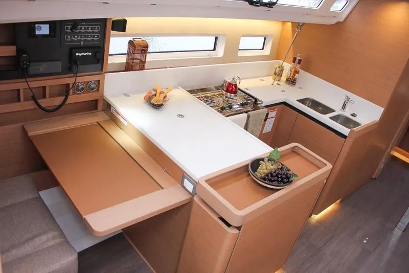 Slide: The Image of Modern kitchen interior of 2025 Jeanneau Sun Odyssey 440 yacht, featuring sleek countertops and appliances. - 3