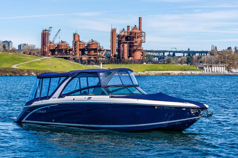 The Image of 2019 Cobalt R30 boat on water with industrial backdrop and clear sky. - 0