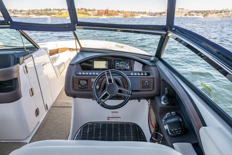 Slide: The Image of Cockpit view of 2019 Cobalt R30 boat with steering wheel and control panel. - 11