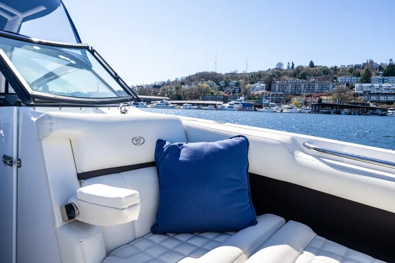 Slide: The Image of Luxurious 2019 Cobalt R30 boat interior with blue cushion, overlooking scenic waterfront. - 13