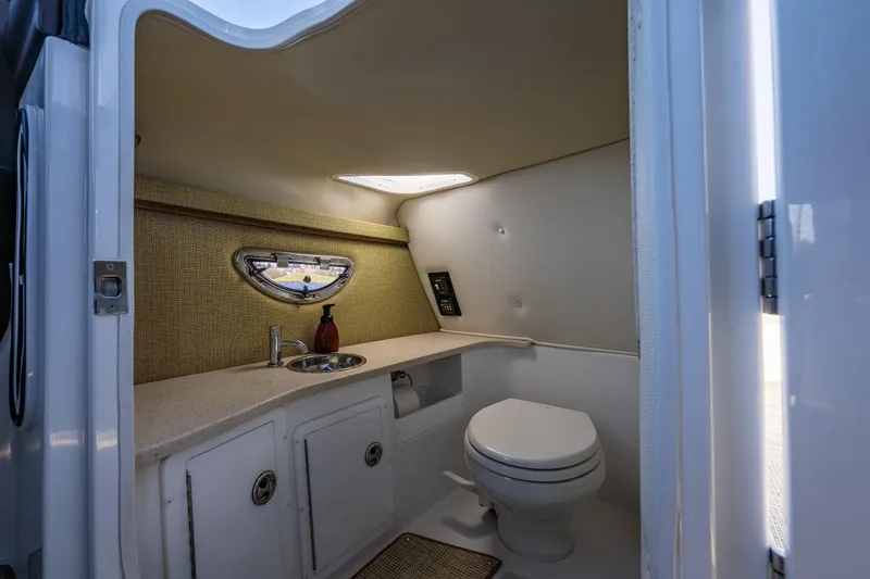Slide: The Image of 2019 Cobalt R30 boat interior bathroom with sink, toilet, and window. - 14