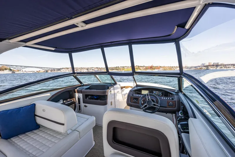 Slide: The Image of 2019 Cobalt R30 boat interior with steering wheel, seating, and scenic water view. - 4