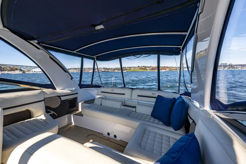 Slide: The Image of Interior view of 2019 Cobalt R30 boat with blue canopy and comfortable seating. - 5