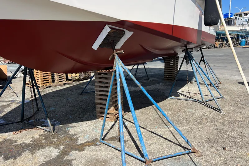 Slide: The Image of 2007 Larson Cabrio 310 boat on stands for maintenance at a shipyard. - 10