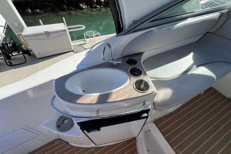Slide: The Image of 2007 Larson Cabrio 310 boat interior with sink and seating area. - 17