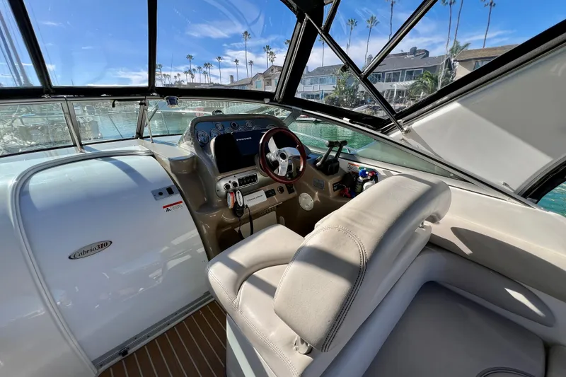 Slide: The Image of Interior view of 2007 Larson Cabrio 310 boat cockpit with steering wheel and dashboard. - 20