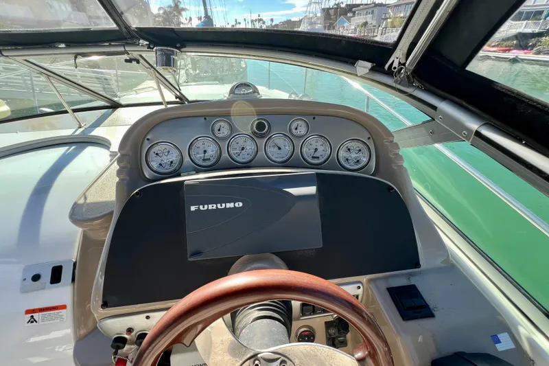 Slide: The Image of 2007 Larson Cabrio 310 boat dashboard with gauges and Furuno navigation system. - 23