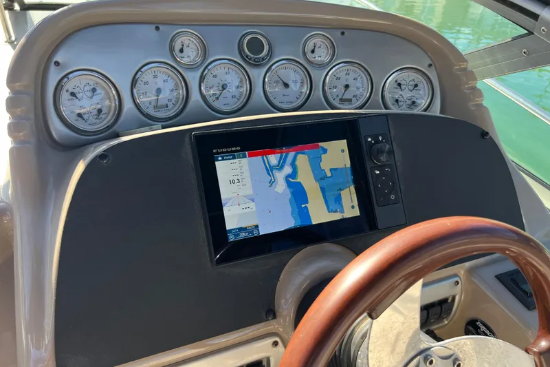Slide: The Image of Dashboard of a 2007 Larson Cabrio 310 boat with navigation system and gauges. - 24
