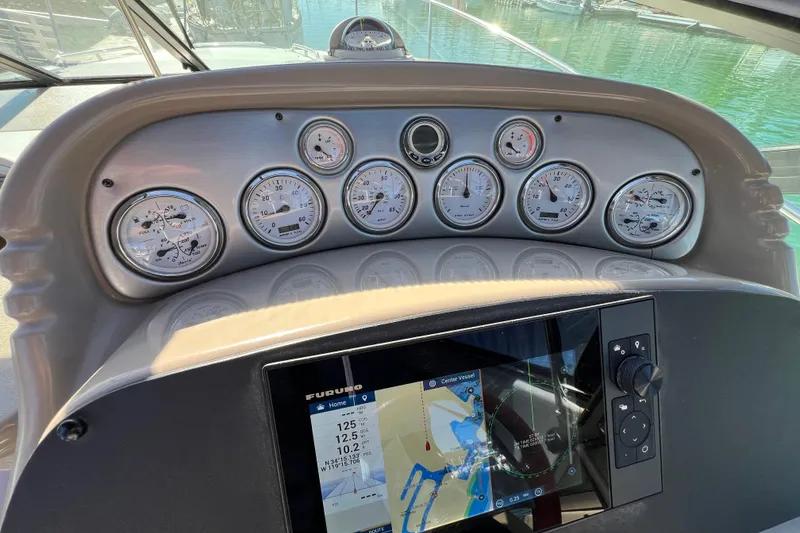 Slide: The Image of Dashboard of a 2007 Larson Cabrio 310 boat with gauges and navigation display. - 25