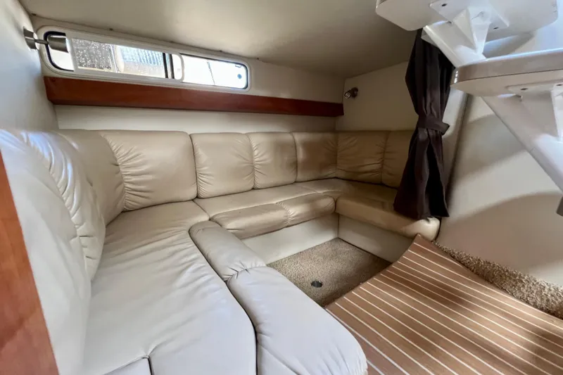 Slide: The Image of Interior of 2007 Larson Cabrio 310 boat with beige leather seating and striped carpet. - 31