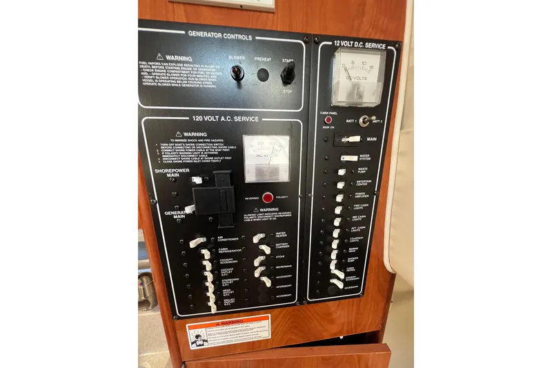 Slide: The Image of Control panel of a 2007 Larson Cabrio 310 boat, featuring generator and electrical services. - 33