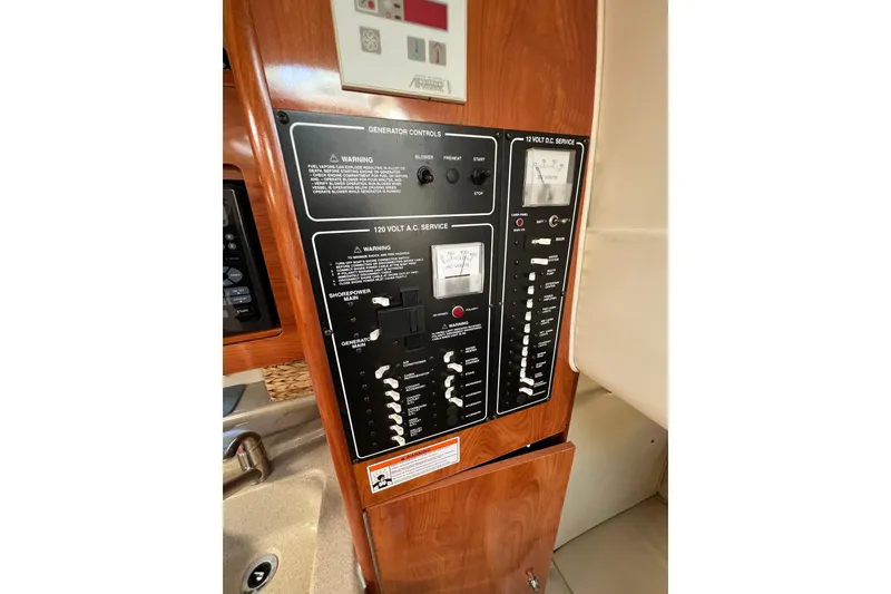 Slide: The Image of Control panel of a 2007 Larson Cabrio 310 boat, featuring generator and electrical service. - 34