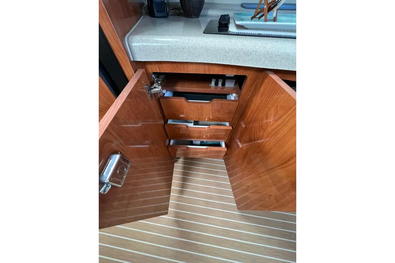 Slide: The Image of Open wooden cabinet with drawers in 2007 Larson Cabrio 310 boat interior. - 39