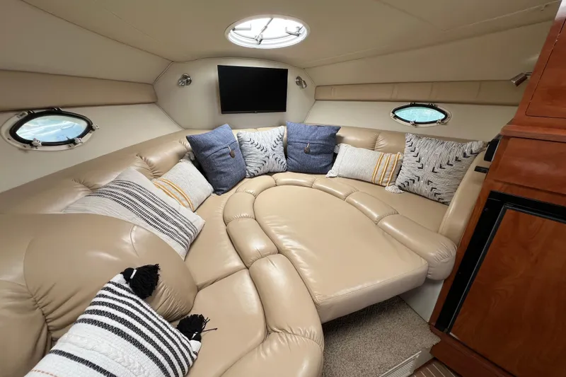 Slide: The Image of Luxurious interior of a 2007 Larson Cabrio 310 boat with plush seating and cushions. - 44
