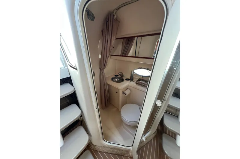Slide: The Image of 2007 Larson Cabrio 310 boat bathroom with sink, toilet, and mirror. - 49