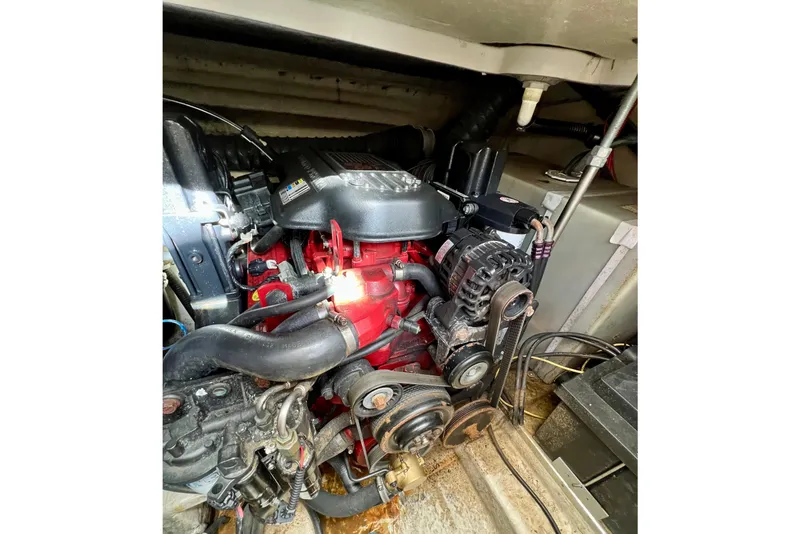 Slide: The Image of Engine compartment of a 2007 Larson Cabrio 310 boat, showcasing mechanical components. - 52