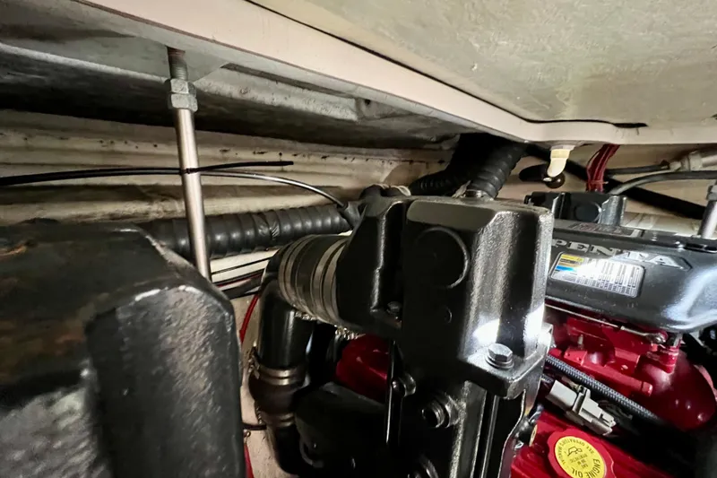 Slide: The Image of Engine compartment of a 2007 Larson Cabrio 310 boat, showcasing mechanical components. - 56