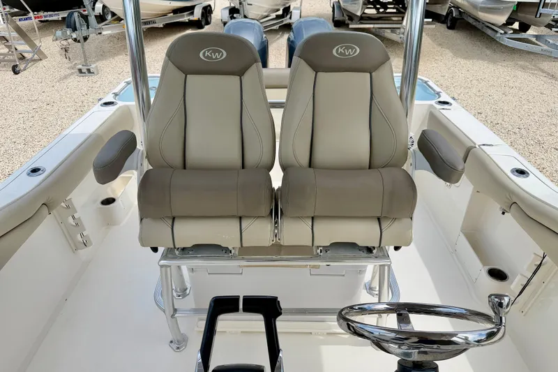 Slide: The Image of 2021 Key West 263 FS boat interior with dual captain's chairs and steering wheel. - 11