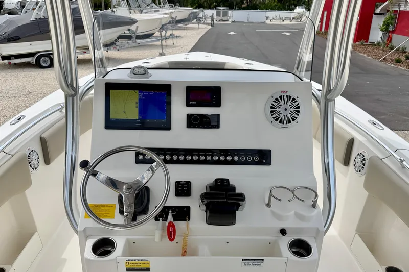 Slide: The Image of 2021 Key West 263 FS boat dashboard with steering wheel and navigation display. - 12