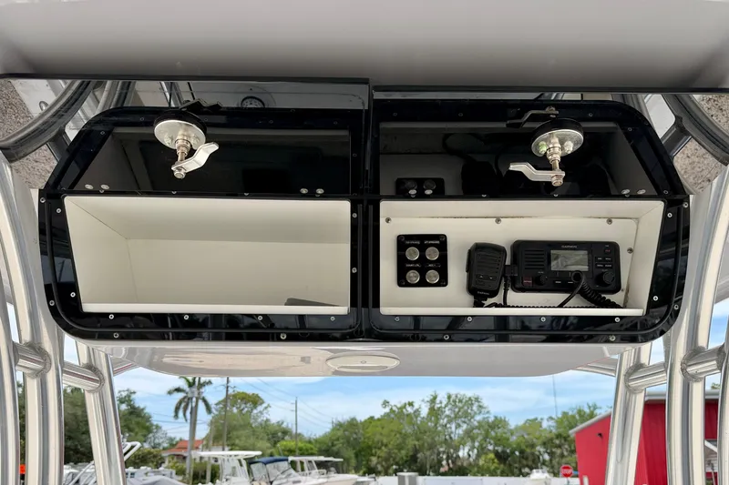 Slide: The Image of 2021 Key West 263 FS boat console with storage compartments and communication equipment. - 17