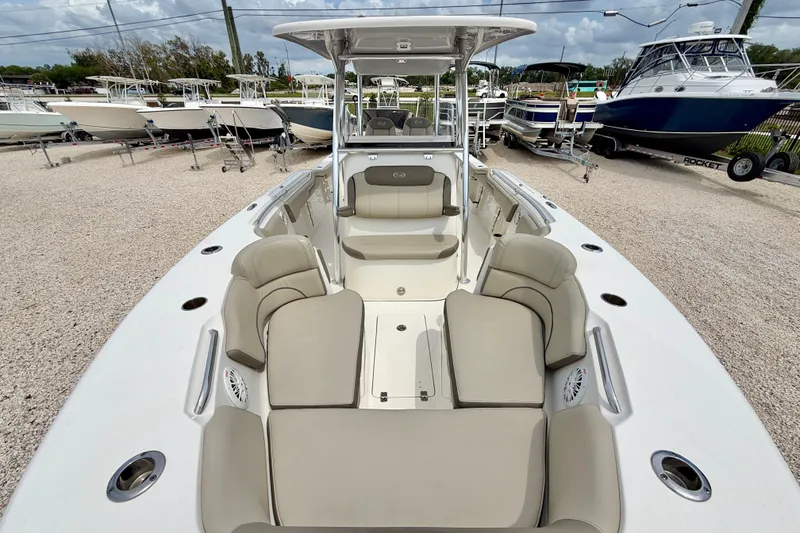 Slide: The Image of 2021 Key West 263 FS boat with spacious seating, displayed in a marina setting. - 21