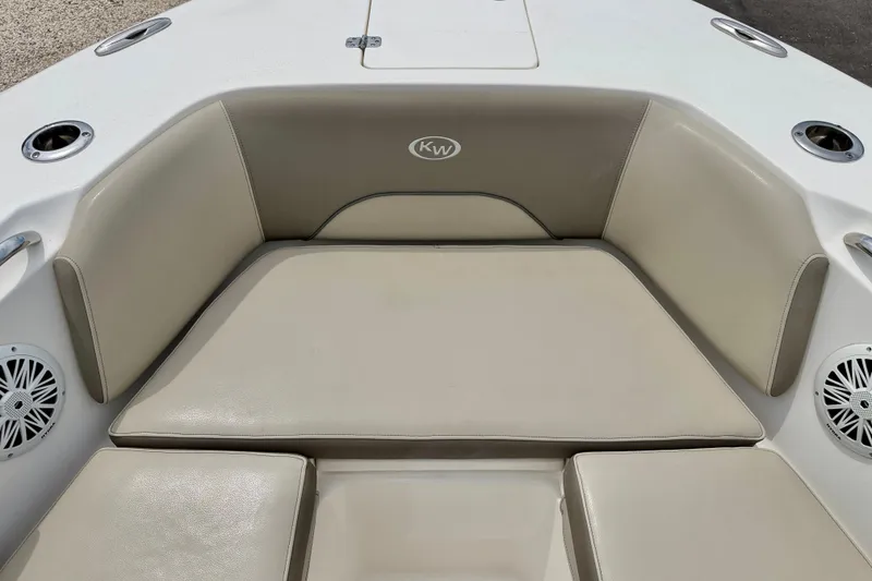Slide: The Image of 2021 Key West 263 FS boat seating area with beige cushions and speakers. - 23
