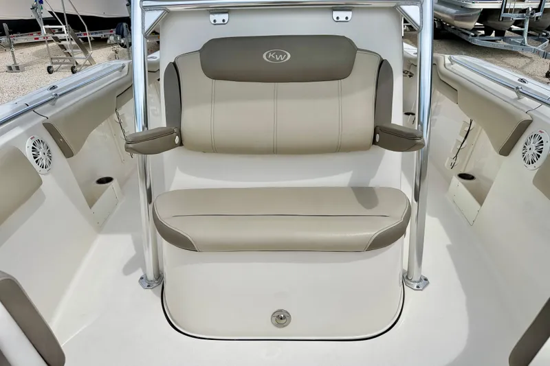 Slide: The Image of 2021 Key West 263 FS boat interior with beige seating and stainless steel frame. - 26