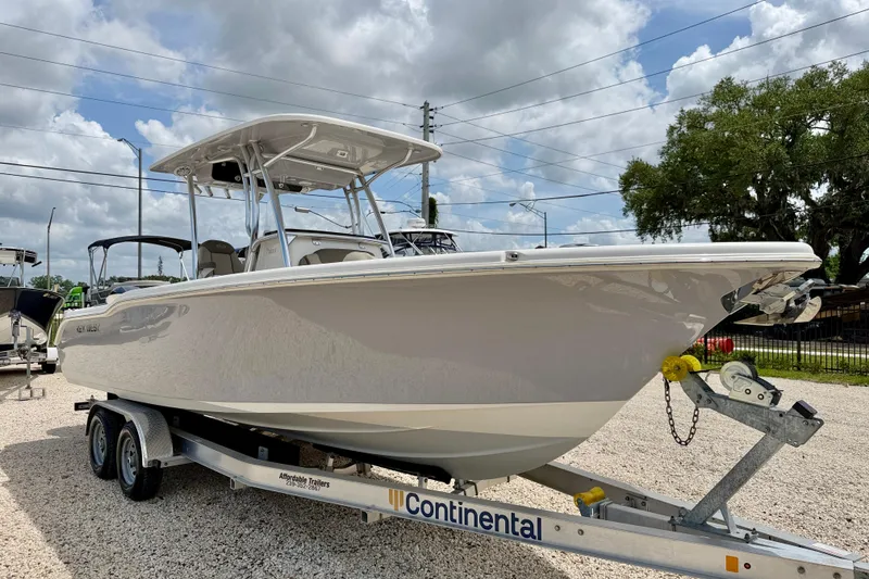 Slide: The Image of 2021 Key West 263 FS boat on trailer under cloudy sky. - 3