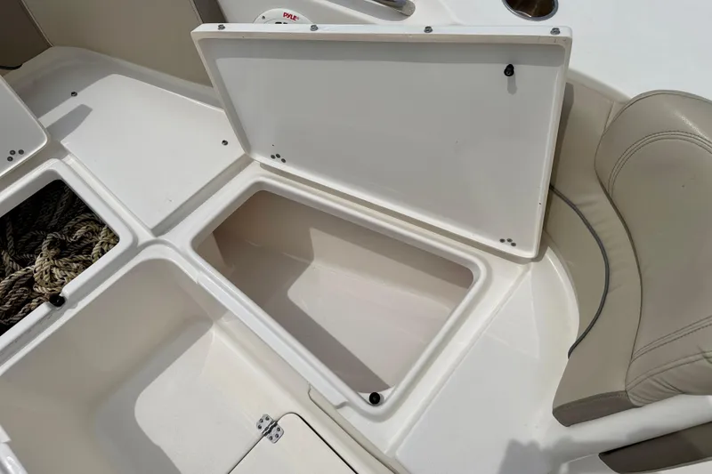 Slide: The Image of Open storage compartments on a 2021 Key West 263 FS boat deck. - 30