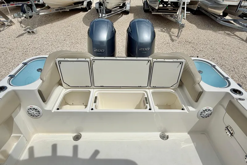 Slide: The Image of 2021 Key West 263 FS boat interior with storage compartments and dual engines. - 35