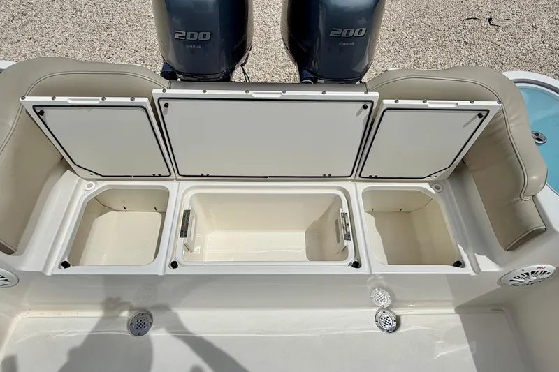 Slide: The Image of 2021 Key West 263 FS boat with open storage compartments and twin Yamaha 200 engines. - 36