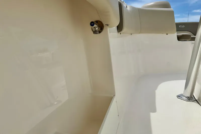 Slide: The Image of 2021 Key West 263 FS boat interior with beige seating and stainless steel fixtures. - 44