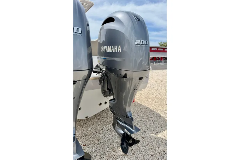 Slide: The Image of Yamaha 200 outboard motor on 2021 Key West 263 FS boat, parked on gravel. - 47